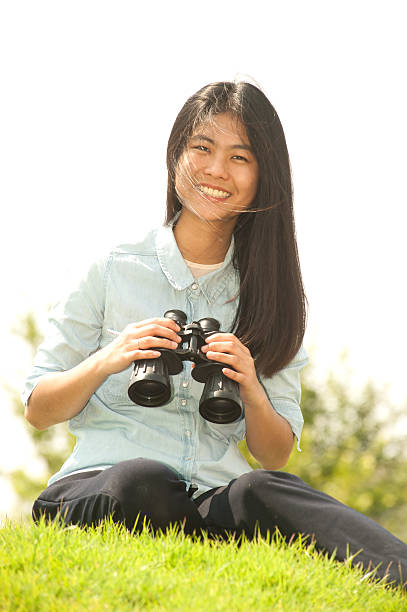 istock Pretty Asian woman sit on mound seeking Binoculars . 524534536