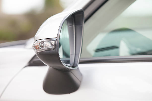 istock Side rear-view mirror closed for safety at car park. 524535086