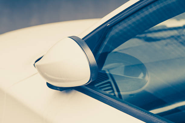istock Side rear-view mirror closed for safety at car park. 524535104
