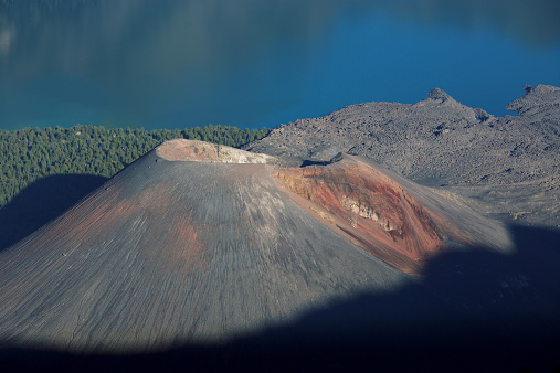 Aerial view of Lonquimay volcano behind a mountain in La Araucania region, southern Chile