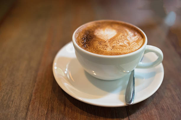 istock Hot coffee in white cup and saucer top view 524537510