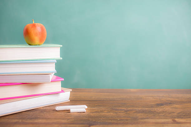 istock Back to school. Education. Textbooks, apple on desk. Chalkboard. 524537590