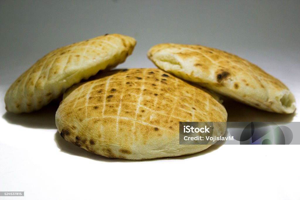 Bunch of freshly baked buns 5 Photo of a bunch of freshly baked buns and breads in different sizes stacked up on a white background Baked Stock Photo