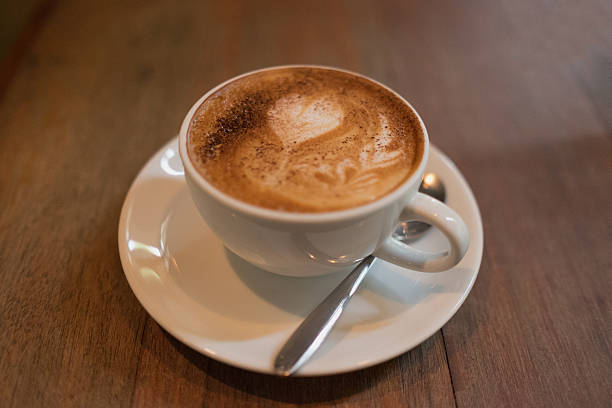 istock Hot coffee in white cup and saucer top view 524537826