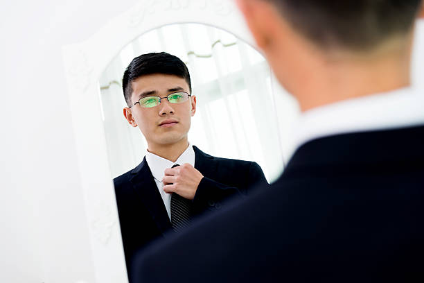 istock Young asian businessman adjusting necktie 524538732