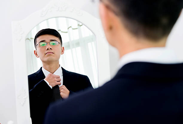 istock Young asian businessman adjusting necktie 524538770