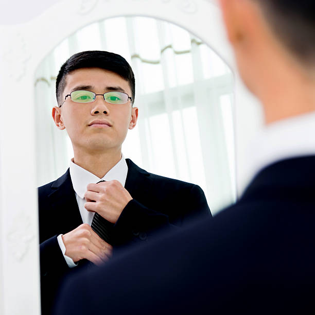 istock Young asian businessman adjusting necktie 524538802