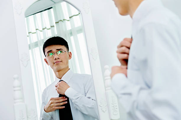 istock Young asian businessman adjusting necktie 524538890