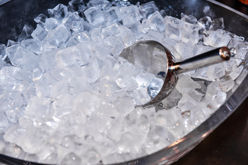ice with scoop in ice bucket, preparation of ice in a bar for event party