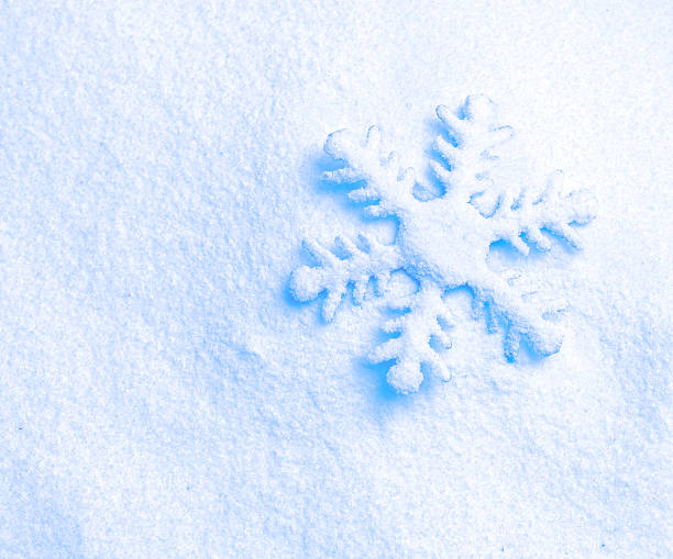istock snowflake against a background of snow 524539101