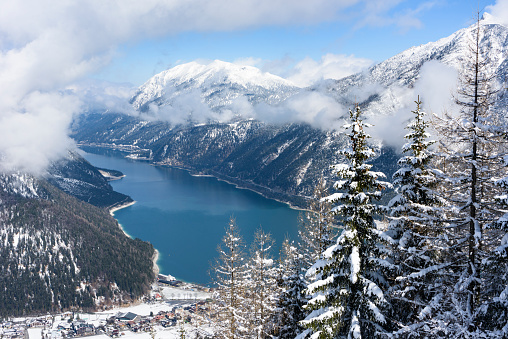 View from the mountain Zwölferkopf over the lake Achen (German: Achensee) and the village Pertisau at the end of the winter season (Austria, Tyrol).