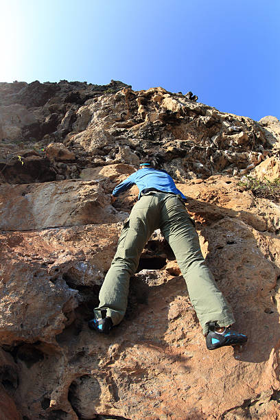 istock young woman rock climber climbing at seaside mountain rock 524541300