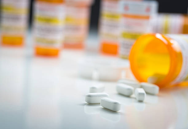 istock Medicine Bottles Behind Pills Spilling From Fallen Bottle 524541346