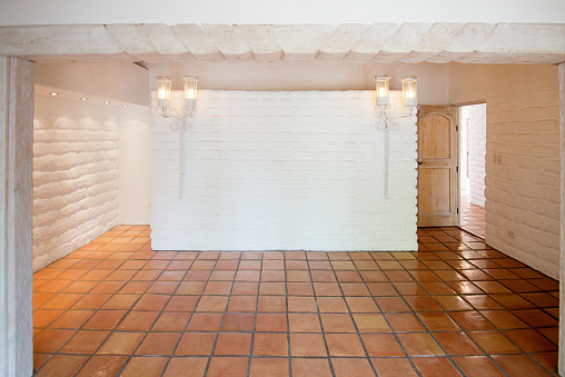 Empty Rustic Room with White Adobe Brick Wall and Tiles