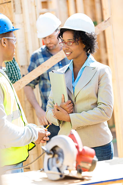 istock Home builder and building foreman meet at job site 524542422