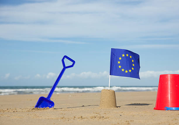 istock European communities flag on a beach with red bucket 524542554