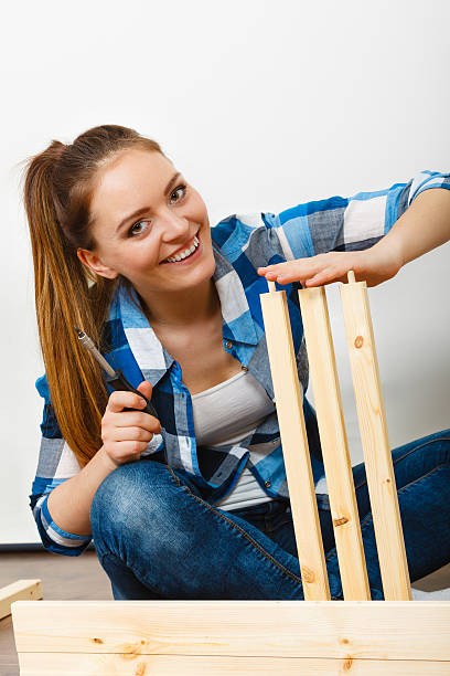 istock Woman assembling wooden furniture. DIY. 524543884