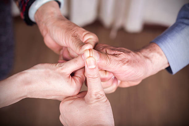 istock family love:senior parents and next generation hand touching 524544110