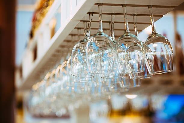istock Empty glasses for wine above bar rack. Hanging wine glasses 524546044