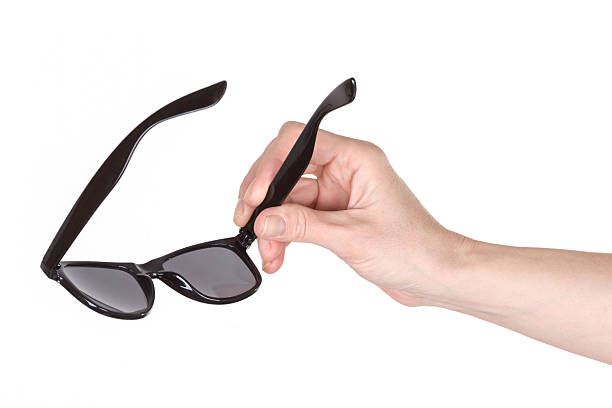 istock Female hand holding sunglasses 524547654