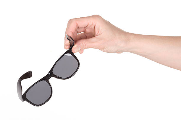 istock Female hand holding sunglasses 524547732