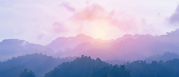 Colorful from sunrise Sunrise from the edge of foggy mountain after raining in the night. The colors of sky and mountains change to purple and blue. night sky only stock pictures, royalty-free photos & images