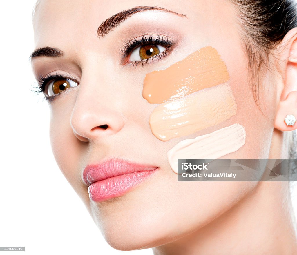 Beautiful face of  woman with cosmetic foundation on a skin Beautiful face of  young woman with cosmetic foundation on a skin.   Beauty treatment concept Foundation Make-Up Stock Photo