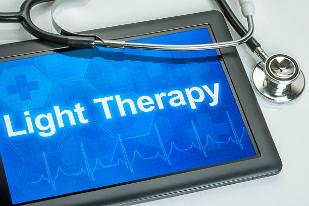 Tablet with the diagnosis Light Therapy on the display Tablet with the diagnosis Light Therapy on the display light therapy stock pictures, royalty-free photos & images