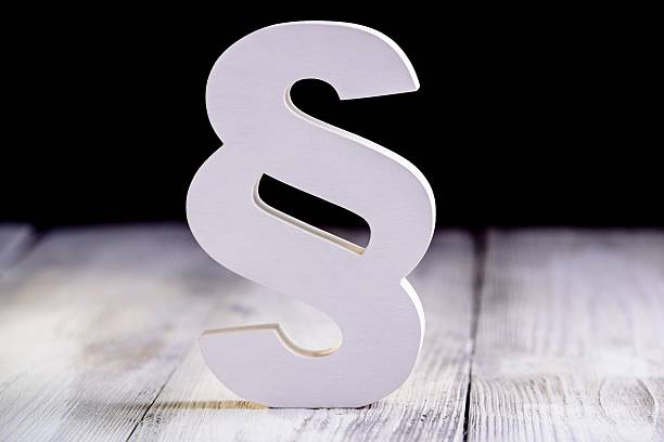 istock White wooden paragraph - law symbol on black 524551668