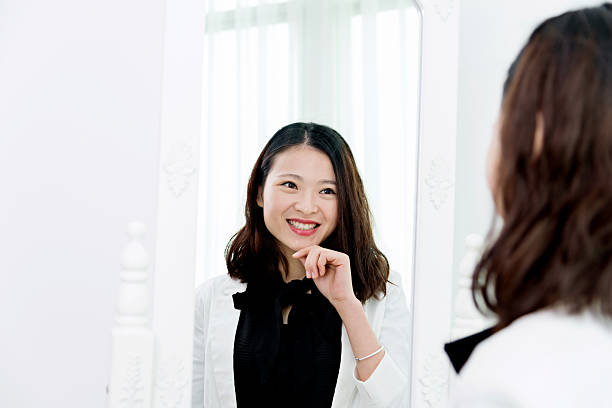 istock Attractive young woman looking at herself 524552246