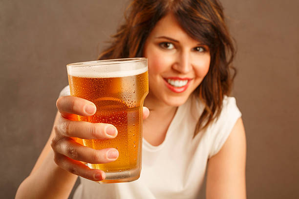 istock Cheers Young woman sitting in a bar and drinking beer 524552420