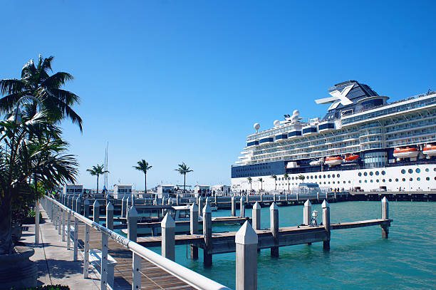 Key West, United States - February 5, 2016: People walk at the sunny Key West pier near cruise ship and Atlantic Ocean.