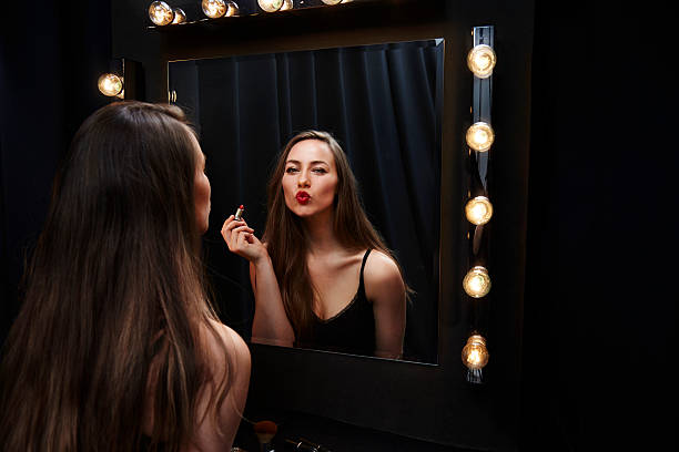 istock Beautiful woman in make up mirror blowing a kiss 524554726