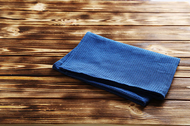istock Napkin on brown wooden table, close up 524556390