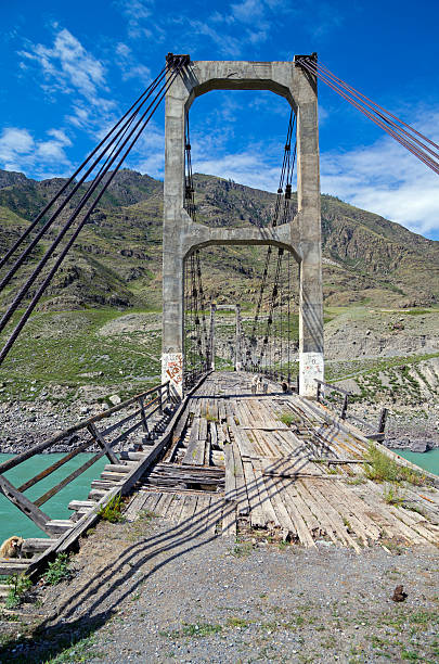 istock Abandoned bridge over the river Katun, Altai. 524575995