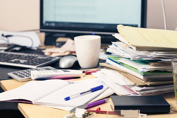 messy desk paperwork stack of brochures, files and documents, on mess desktop, monitor of pc in background cluttered photos stock pictures, royalty-free photos & images