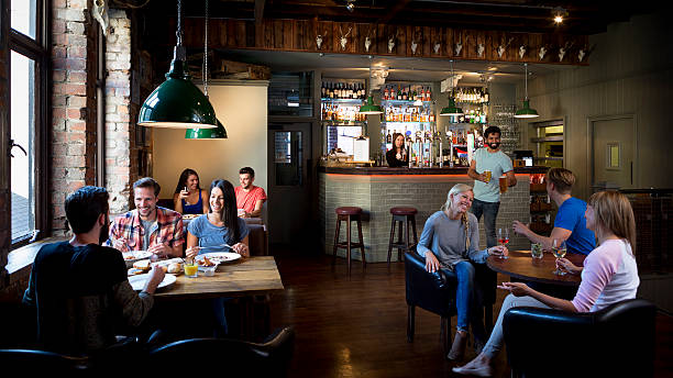 Busy Bar Scene Busy bar scene. pub stock pictures, royalty-free photos & images