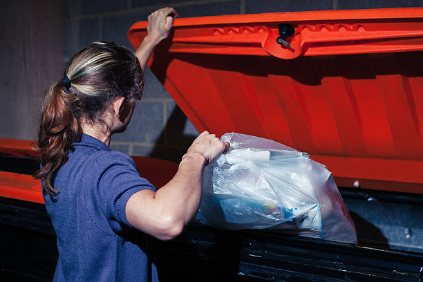 istock Woman putting rubbish in bin 524579219