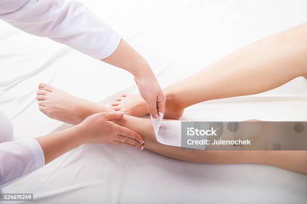 Beautician Waxing Woman Legs In Spa Salon Stock Photo - Download Image Now - Adult, Applying, Beautician