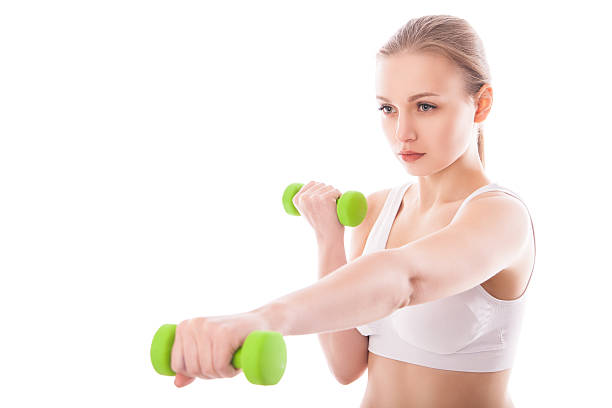 istock Athletic woman pumping up muscles with dumbbells 524619317
