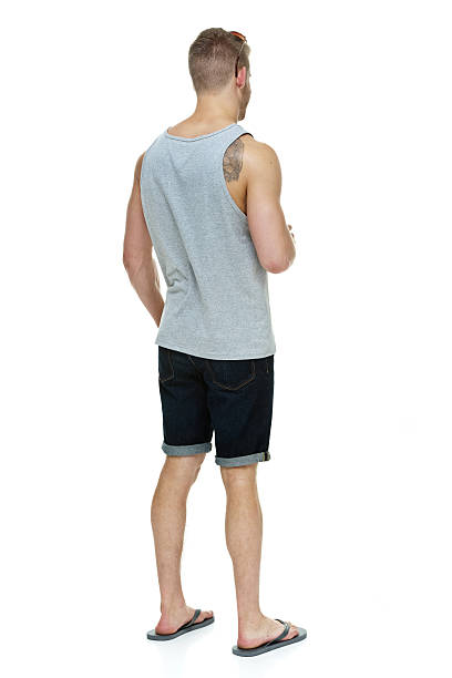 Rear view of casual man looking away Rear view of casual man looking awayhttp://www.twodozendesign.info/i/1.png body adornment rear view young men men stock pictures, royalty-free photos & images