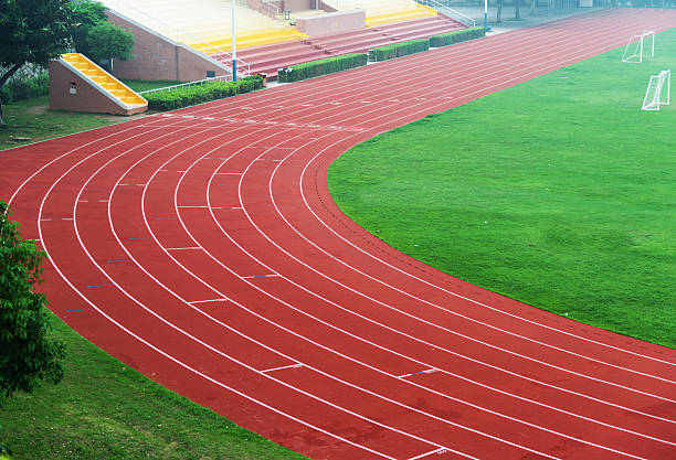 Running track High angle view of running track at a school. track and field stadium stock pictures, royalty-free photos & images