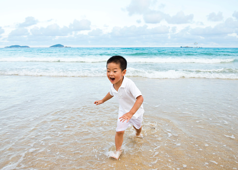 Asian boy have fun on the beach.