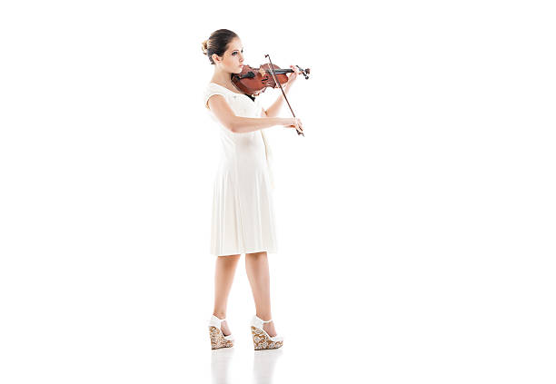 istock Beautiful young woman playing violin over white 524623985