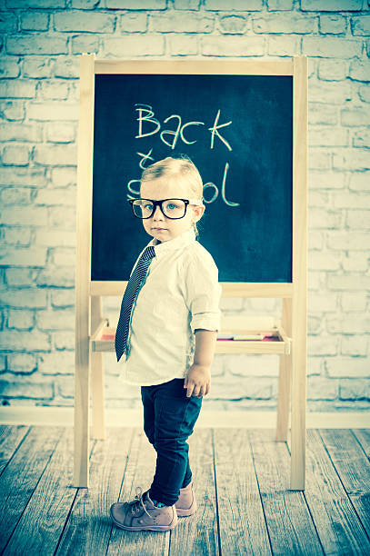 istock Smart little girl stood infront of a blackboard 524624391