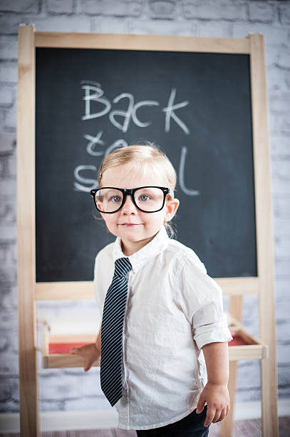 istock Smart little girl stood infront of a blackboard 524624397