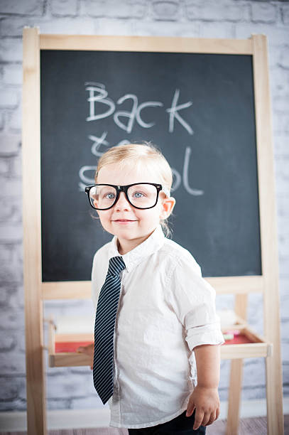 istock Smart little girl stood infront of a blackboard 524624421