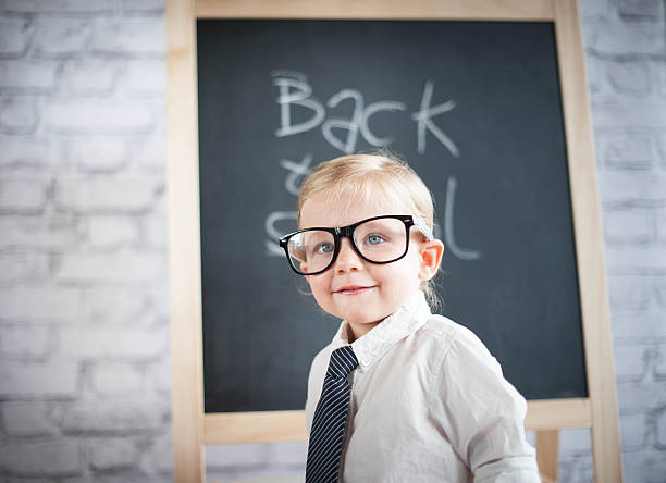 istock Smart little girl stood infront of a blackboard 524624435