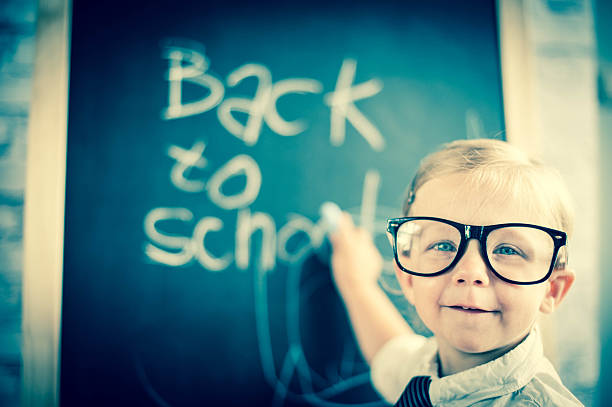 istock Smart little girl stood infront of a blackboard 524625367