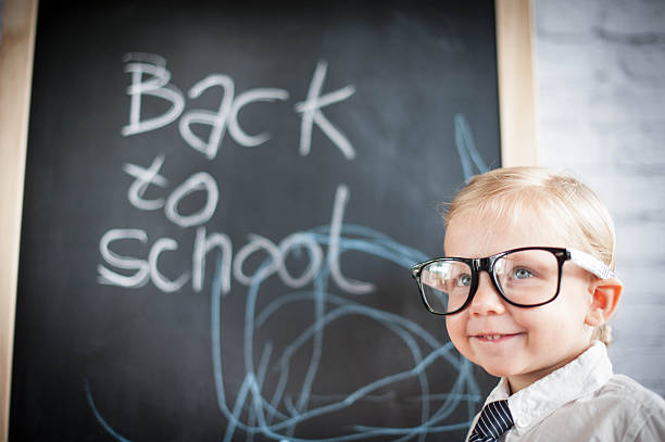 istock Smart little girl stood infront of a blackboard 524625399
